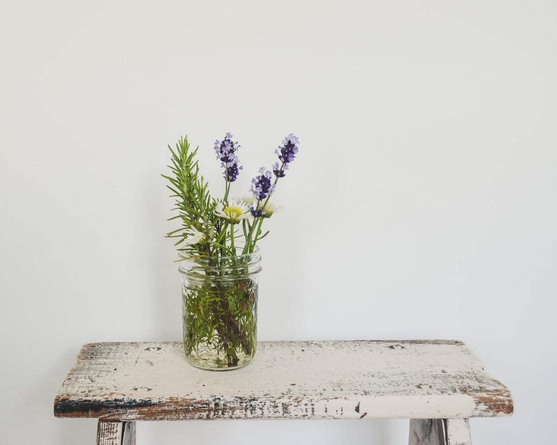 a vase of flowers sitting on top of a wooden table