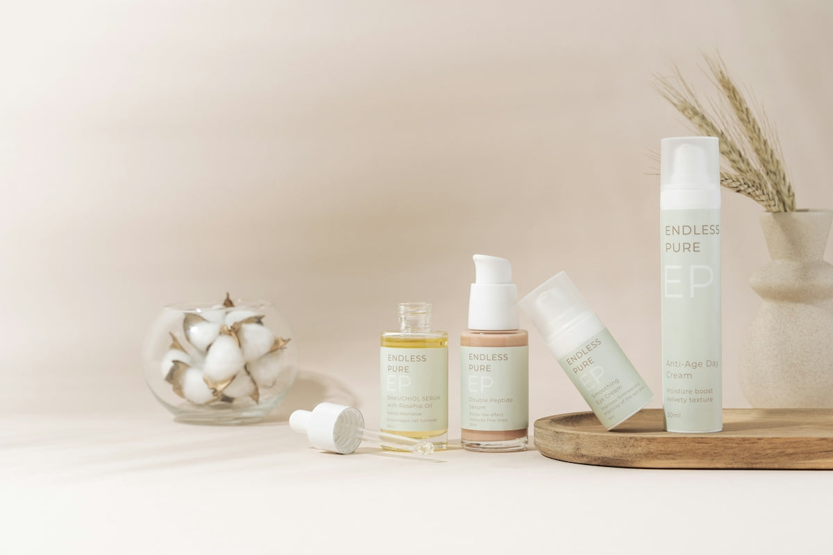 A table topped with bottles and containers filled with skin care products