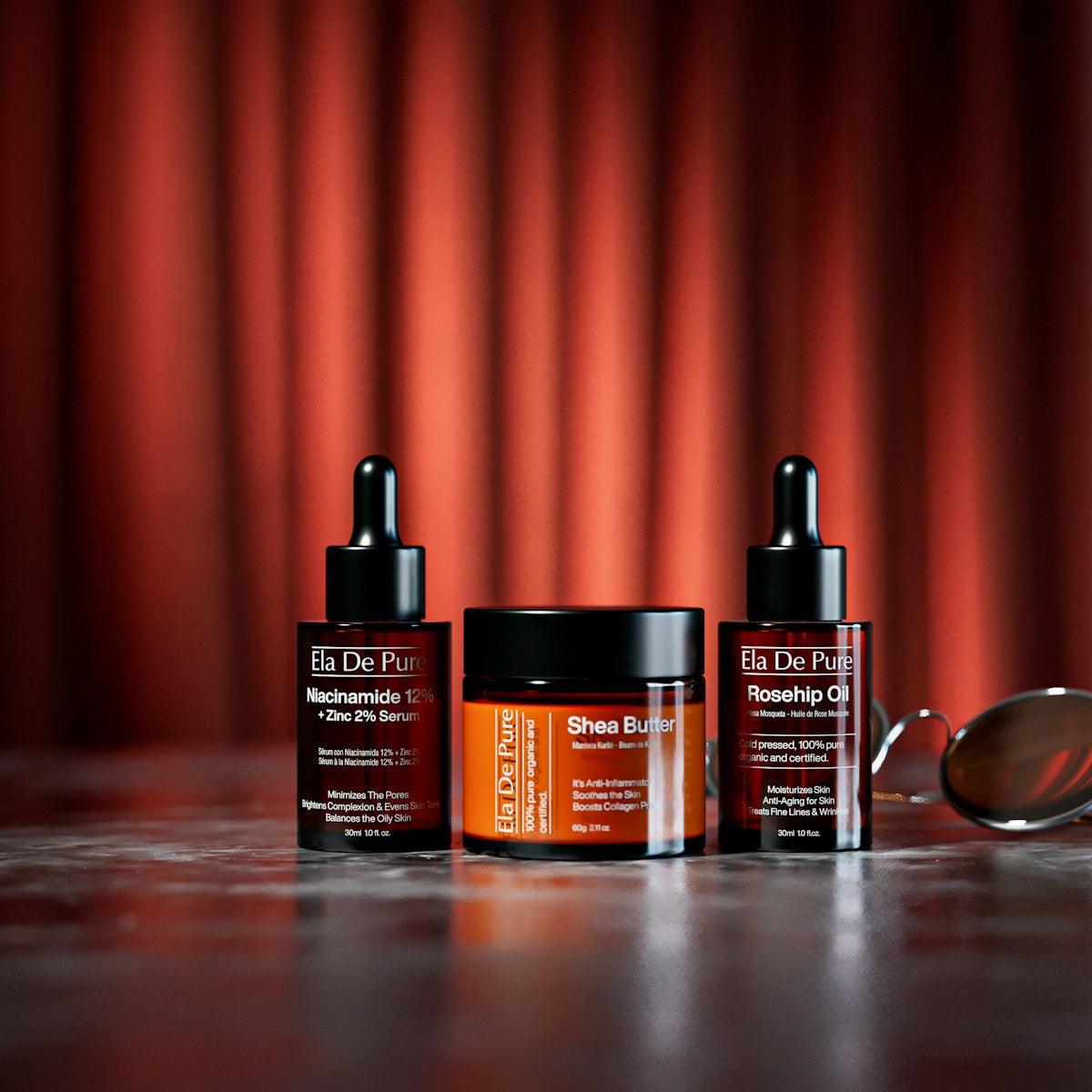 Skincare products and sunglasses on a reflective surface